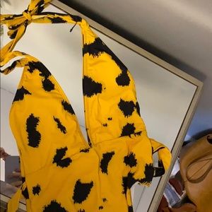 Never worn bath ring suit with back buckle design